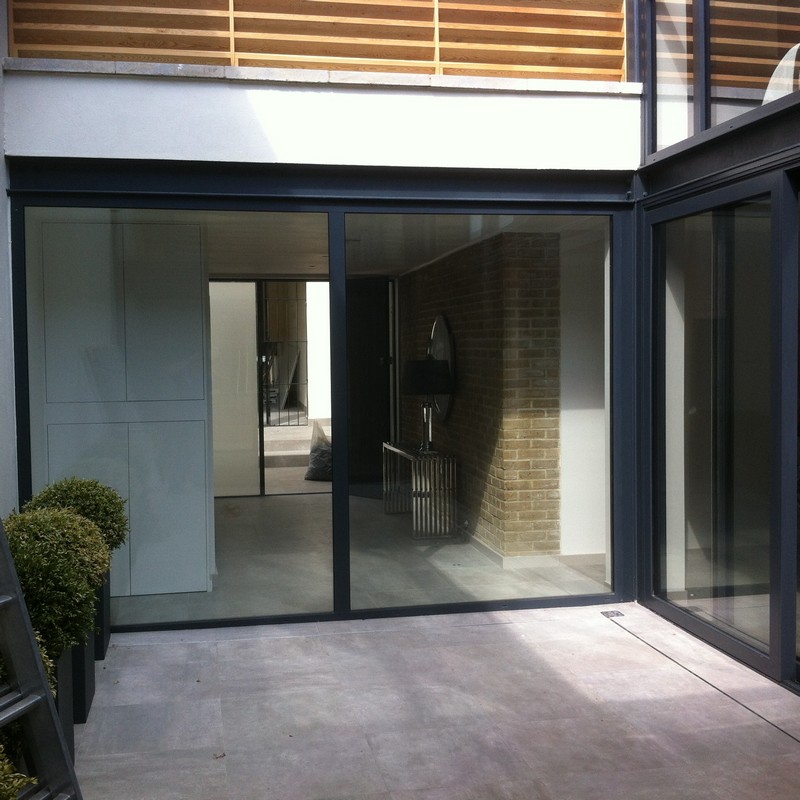 Floor-to-ceiling sliding doors opening to courtyard in Alexandra Palace