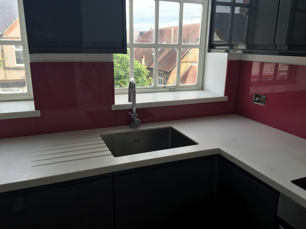 Deep plum coloured glass splashback in modern Alexandra Palace kitchen